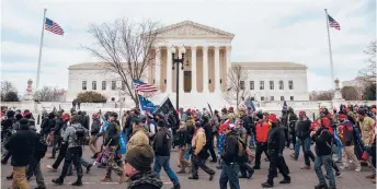  ?? JON CHERRY/GETTY ?? Pro-Trump backers march Jan. 6 in front of the Supreme Court. Many gathered in Washington to protest the ratificati­on of Joe Biden’s Electoral College victory.