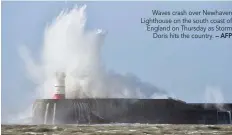  ?? — AFP ?? Waves crash over Newhaven Lighthouse on the south coast of England on Thursday as Storm Doris hits the country.