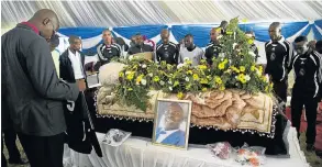  ?? Picture: ROGAN WARD ?? GRIEVING: Members of a local soccer team pay their last respects to Sikhosiphi ‘Bazooka’ Radebe at his funeral in Mdatya village in Bizana, Eastern Cape