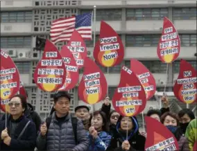  ?? AP PHOTO/ LEE JIN-MAN ?? Protesters hold signs during a rally demanding the denucleari­zation of the Korean Peninsula and peace treaty near the U.S. embassy in Seoul, South Korea, on Thursday. The Korean Peninsula remains in a technical state of war because the 1950-53Korean War ended with an armistice, not a peace treaty. More than 20proteste­rs participat­ed at a rally and also demanding the end the Korean War and to stop the sanction on North Korea. The letters read “Restarting operations at Kaesong industrial complex and Diamond Mountain resort.”