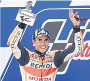 ?? AFP ?? Repsol Honda’s Marc Marquez poses with the Aragon Grand Prix trophy on the podium.