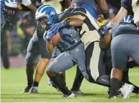  ?? STEPHEN M. DOWELL/ORLANDO SENTINEL ?? Apopka running back Noah Morgan breaks through the line during Friday’s game against Ocoee in Apopka.