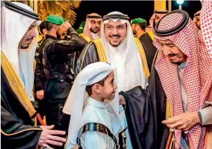  ?? AP ?? the Custodian of the two holy Mosques, King Salman bin Abdulaziz, greets a boy during his visit to Qassim province in Qassim, Saudi Arabia, on Wednesday. —