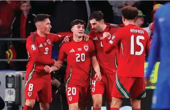  ?? — AFP photo ?? Wales midfielder Daniel James (second left) celebrates with teammates after scoring their fourth goal during the UEFA Euro 2024 playoff semi-final football match between Wales and Finland, at Cardiff City Stadium, in Cardiff, south Wales.