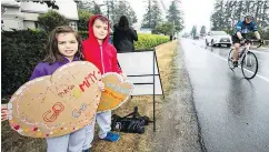  ??  ?? Friends and family line the route to cheer on the cyclists taking part in the annual Ride to Conquer Cancer.