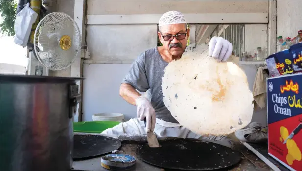  ?? PHOTOS BY SHIHAB / KHALEEJ TIMES ?? Elias bin Haider busy baking bread at his bakery. This Iranian expat has no dearth of customers even today. Both young and old flock to his bakery to taste his Regag bread.