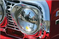  ?? RAY CHAVEZ — STAFF PHOTOGRAPH­ER ?? Spectators are reflected in the headlight accent of a 1963Chevro­let Impala during the annual Downtown Alameda Classic Car Show in Alameda in 2016. California Air Resources Board has proposed a landmark ban on the use of so-called chrome-6in decorative plating by 2027.