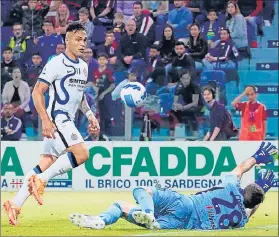  ?? AP ?? Lautaro Martinez lobs the ball over Cagliari goalkeeper Alessio Cragno on Sunday.