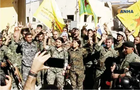  ?? US-backed Syrian Democratic Forces (SDF) fighters celebrate their victory in Raqqa, Syria. ??