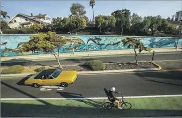  ?? Mel Melcon Los Angeles Times ?? A CYCLIST uses a bike path along Ocean Park Boulevard in Santa Monica. Building more bike lanes in the region is a key goal of transit officials gearing up for the 2028 Olympics, with the idea to reduce trips by cars.