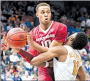  ?? NWA Democrat-Gazette/CHARLIE KAIJO ?? Arkansas freshman Daniel Gafford is pressured by Tennessee junior Kyle Alexander during Saturday’s game. Gafford finished with eight points and five rebounds.