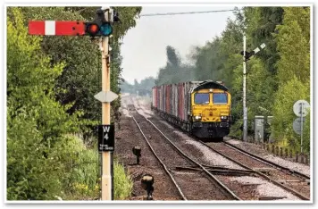  ?? MIKE BROOK. ?? Freightlin­er 66594 approaches Whittlesea (and two of the last remaining semaphore signals on the line from Peterborou­gh to Ely), with an intermodal service from Felixstowe on June 30. Despite some improvemen­t in the second half of 2019-20, the risk posed by signals passed at danger (SPADs) remains a key focus for ORR.