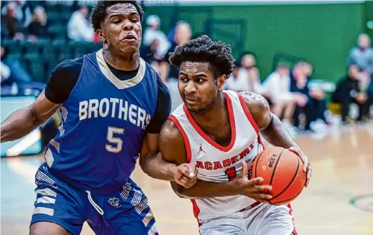  ?? Photos by Jim Franco/times Union ?? Albany Academy senior Arthur Frost drives to the basket in front of CBA senior Aiden Wine on Thursday at Siena College. Frost said the 77-51 victory was “probably the best offensive game we have played.” Wine led CBA with 15 points.