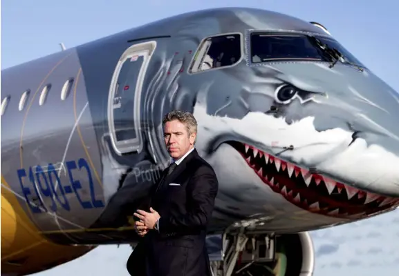  ??  ?? John Slattery, CEO of Embraer Commercial Aviation, with the new Embraer E190-E2 passenger jet. Picture by David Conachy