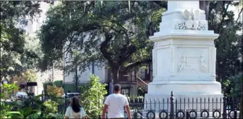  ?? AP Photo/ ruSS Bynum ?? In this Aug. 31, photo people stroll through Monterey Square in the historic landmark district of Savannah, Ga.