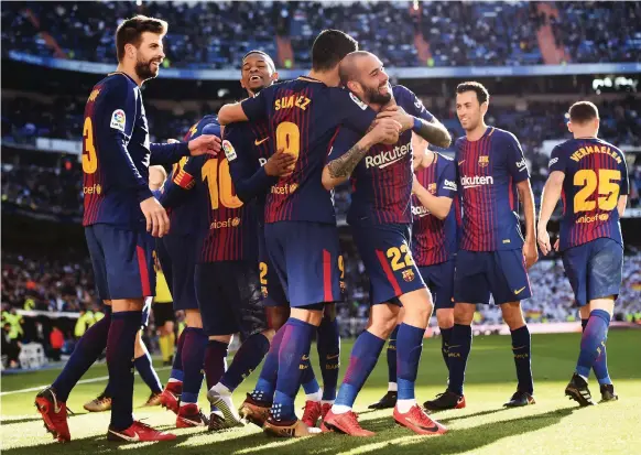  ?? Getty ?? Aleix Vidal, No 22, finished this off for Barcelona with his team’s third goal to defeat host Real Madrid in the first Primera Liga el clasico of the season yesterday