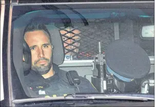  ?? CP PHOTO ?? Basil Borutski peers through a security grill in a police vehicle after appearing at the courthouse in Pembroke, Ont. In a 2015 file photo. On Friday he was found guilty of killing three women in a 2015 rampage.