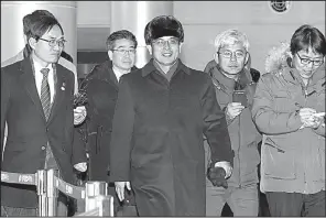  ?? AP ?? Yun Yong Bok (center), deputy director of the North Korean Ministry of Physical Culture and Sports, heads for home Saturday in Paju, South Korea, after inspecting Olympics facilities.