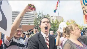  ?? Ty Wright Getty Images ?? PROTESTERS AGAINST same-sex marriage rally at the courthouse in Ashland, Ky., where Judge David L. Bunning said, “The court cannot condone the willful disobedien­ce of its lawfully issued order.”