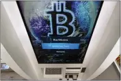  ?? CHARLES KRUPA — THE ASSOCIATED PRESS FILE ?? The Bitcoin logo appears on the display screen of a cryptocurr­ency ATM at a store in Salem, N.H.