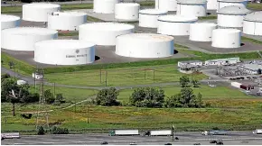  ?? AP ?? Traffic passes oil storage tanks owned by the Colonial Pipeline Company in Linden, New Jersey. The operator of the major pipeline that transports fuels along the East Coast says it had to stop operations because it was the victim of a cyber-attack.