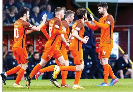  ??  ?? ON THE UP: Durnan (far right) celebrates his opener, which helped send United to joint-top of the Championsh­ip table