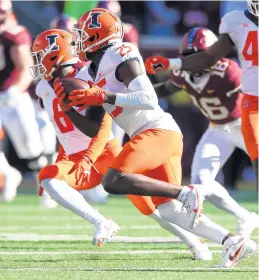  ?? DAVID BERDING/GETTY ?? Kerby Joseph of Illinois intercepts a pass by Minnesota’s Tanner Morgan #2 of the Minnesota Golden Gophers (not pictured) in the fourth quarter on Saturday. The Fighting Illini defeated the No. 20 Golden Gophers 14-6.