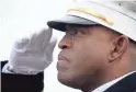  ?? ?? Mesa Deputy Fire Chief Forrest Smith salutes as Capt. Trevor Madrid’s casket arrives Tuesday. Madrid died Nov. 14 after a battle with synovial sarcoma as a result of job-related exposures.