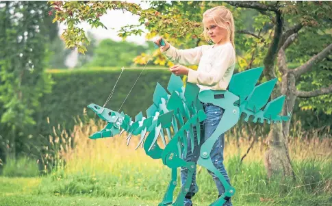  ?? ?? PREHISTORY LESSON: A child plays in a Dinosuit created by Aberfeldy art teacher and entreprene­ur Ross Padgett.