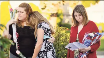  ?? Contribute­d photo ?? Victoria Higley-Pratt, left, holds daughter Robyn Higley as older daughter Amanda Higley looks at the program during a 9/11 memorial ceremony in Danbury on Sept. 11, 2012. Higley-Pratt lost her husband, Robert, in the terrorist attacks in 2001, two months before Robyn was born.