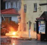  ?? PETE BANNAN – DIGITAL FIRST MEDIA ?? An arcing wire burns on the side of Sabatino’s Grill in West Bradford on Monday. Building resident John Kelly said the wire had fallen about noon across from Route 322; he notified PECO. At 3 p.m. the wire began to arc, which brought out West Bradford,...