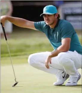  ?? MIKE GROLL - THE ASSOCIATED PRESS ?? Brooks Koepka, who will play in the Travelers Championsh­ip, lines up a putt on the 14th hole during the first round of the PGA Championsh­ip at Baltusrol Golf Club Thursday.