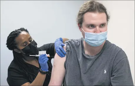  ?? BEN GRAY — THE ASSOCIATED PRESS ?? Cole Smith receives a Moderna variant vaccine shot from clinical research nurse Tigisty Girmay at Emory University’s Hope Clinic, on March 31, in Decatur, Ga. Smith, who received Moderna’s original vaccine a year ago in a first-stage study, said returning wasn’t a tough decision.