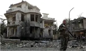  ?? Photograph: Reuters ?? An Afghan soldier keeps watch at the site of a car bombing in Kabul. A resurgent Taliban has swept across Afghanista­n capturing large swathes of territory in less than a week.