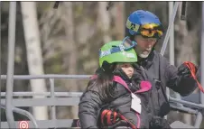  ?? ?? Peter Donahue helps his student get off the lift on Thursday.