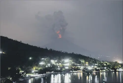  ??  ?? A view of the Mount Agung volcano erupting in Bali, Indonesia, as the risk of a major blast was raised to its highest level yesterday.