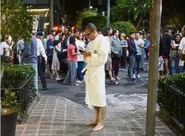  ??  ?? People gathering on a street in downtown Mexico City following the powerful tremor. — AFP Rush to safety: