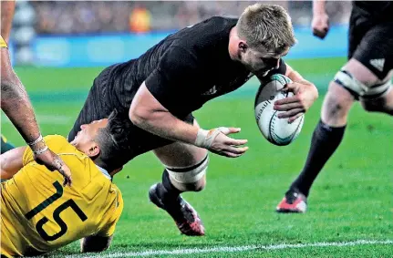  ??  ?? New Zealand's Sam Cane (R) scores a try as he is tackled by Australia's Israel Folau during the rugby Test match at Westpac Stadium in Wellington on Saturday - Pic AFP