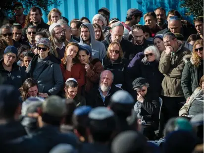  ?? (Yonatan Sindel/Flash90) ?? FRIENDS AND FAMILY attend the funeral of Ori Ansbacher in Tekoa on Friday. The 19-year-old woman was murdered the day before in Ein Yael, on the outskirts of Jerusalem. Hebron native Arafat al-Rifaiyeh has been arrested.
