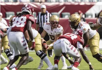  ?? AP FILE ?? BIG ONE THIS WEEK: Boston College quarterbac­k Dennis Grosel takes the snap against Temple during the second half on Saturday.