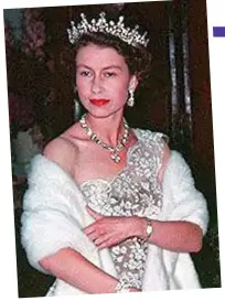  ??  ?? Daring to bare: Queen Elizabeth, aged 28, in a Norman Hartnell lace gown in 1954