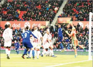  ?? LINDSEY PARNABY / AFP ?? Manchester United striker Wayne Rooney (second left) scores against Stoke for his 250th United goal, making him the club’s all-time record scorer on Saturday.