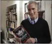  ?? STEVEN SENNE — THE ASSOCIATED PRESS FILE ?? Brown University professor David I. Kertzer holds his book “The Pope and Mussolini: The Secret History of Pius XI and the Rise of Fascism in Europe” in his office, Monday in Providence, R.I.