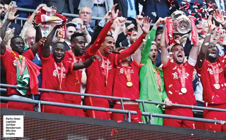  ?? ?? Party time: captain Jordan Henderson lifts the trophy