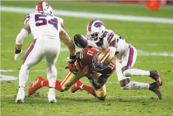  ?? Christian Petersen / Getty Images ?? A pass intended for the 49ers’ Brandon Aiyuk, being covered by Buffalo cornerback Tre’Davious White, ricocheted off linebacker A. J. Klein ( 54) and resulted in an intercepti­on.