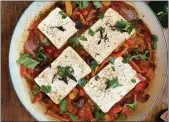  ?? COURTESY OF LYNDA BALSLEV ?? Slabs of feta cheese are braised in a jammy compote of blistered tomatoes and sweet peppers.