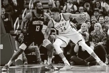  ?? Stacy Revere / Getty Images ?? James Harden and Giannis Antetokoun­mpo, the last two NBA MVPs, will face off Sunday night.