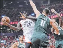  ?? Nathan Denette The Associated Press ?? Raptors forward Pascal Siakam drives in the second half, only to be met by Bucks center Brook Lopez.