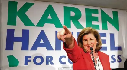  ?? CURTIS COMPTON/CCOMPTON@AJC.COM ?? Karen Handel recognizes her supporters while thanking them during an early appearance after the first returns came in during her election night party in the 6th District race with Jon Ossoff on Tuesday in Atlanta.