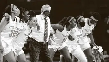  ?? Photos by Cassie Stricker / Bryan-College Station Eagle ?? A&M coach Gary Blair and his players sway to the “Aggie War Hymn” after Sunday’s victory over Tennessee at Reed Arena. Texas A&M improved to 19-1 overall and 10-1 in the Southeaste­rn Conference.